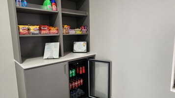 A snack and drink vending area with various snacks and beverages.