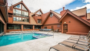 A pool area with lounge chairs and a clear sky. - Ski in Ski out with a view. Fantastic 2 bed condo. (Park City)