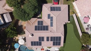 A rooftop with solar panels, a swimming pool, and a tennis court. - 3 bedroom house w/Private Pool, Spa&Golf Course! (La Quinta)