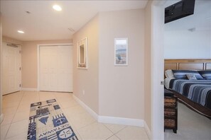 A bedroom with a bed, a headboard, and a window. - Sanibel Condo #902 3/3 Oceanfront Panoramic Views (Daytona Beach Shores)