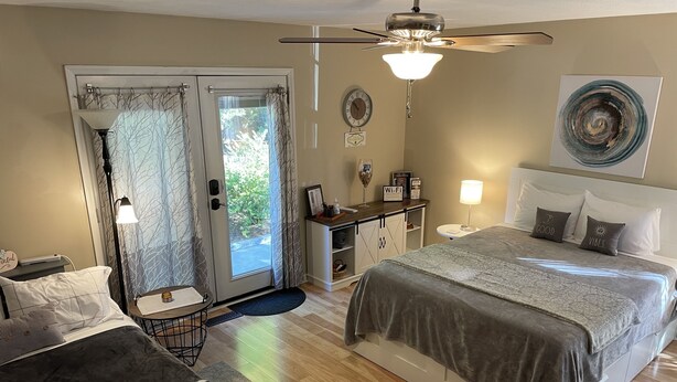A bedroom with a bed, a desk, a chair, a ceiling fan, and a view through a glass door. - Located in # 6 golf community, close to First Health Moore Regional Hospital.  (Pinehurst)