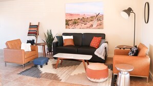 A modern living room with a sofa, two armchairs, a coffee table, and a floor lamp. - 18A4 Moab Adventure! Pool with Red Rock Views (MOAB)
