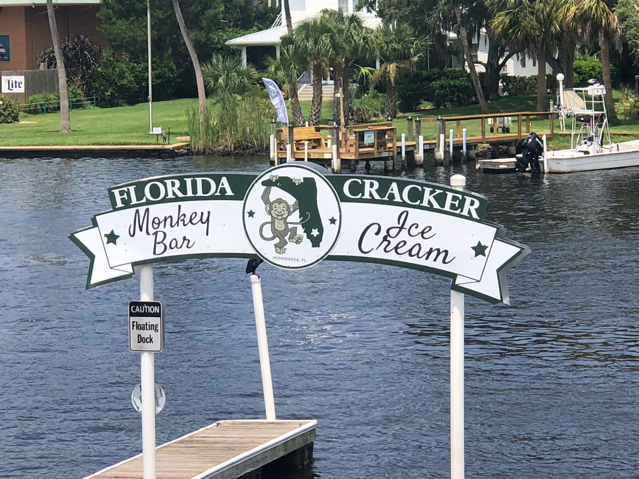 A floating dock with a sign for Florida Monkey Bar and Cracker Ice Cream.
