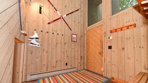 A wooden room with a colorful striped rug, a ski cross, and a 'Let it snow' sign. - Spacious Kearsarge Woods Unit w Association Pool & Tennis 2 Mins to Downtown (North Conway)