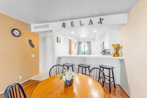 Enjoy meals in a serene dining area with a round table and comfortable seating for four.