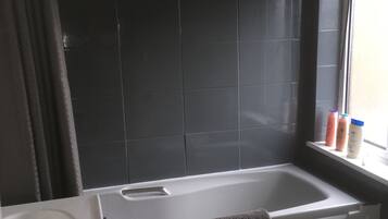 Combined shower/bathtub, hair dryer, towels, soap