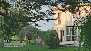 A building with a large window, a door, and a balcony. - "Da Celeste" Very bright apartment in a single house surrounded by greenery (Montegaldella)