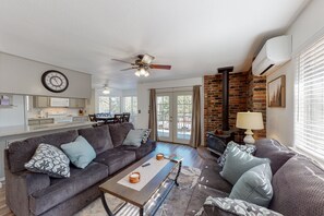 A modern living room with a grey sofa, coffee table, and a fireplace.