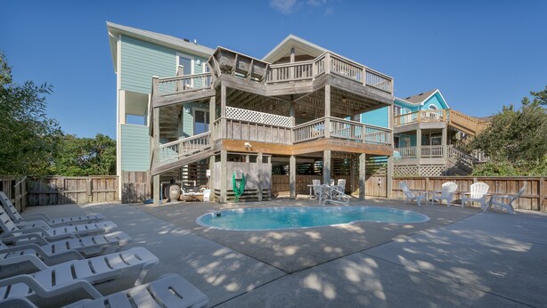 A multi-level wooden building with a swimming pool and outdoor seating. - 1623 - Breakaway - Bring the Pup! Corolla Escape w/ Pool & Hot Tub (Corolla)