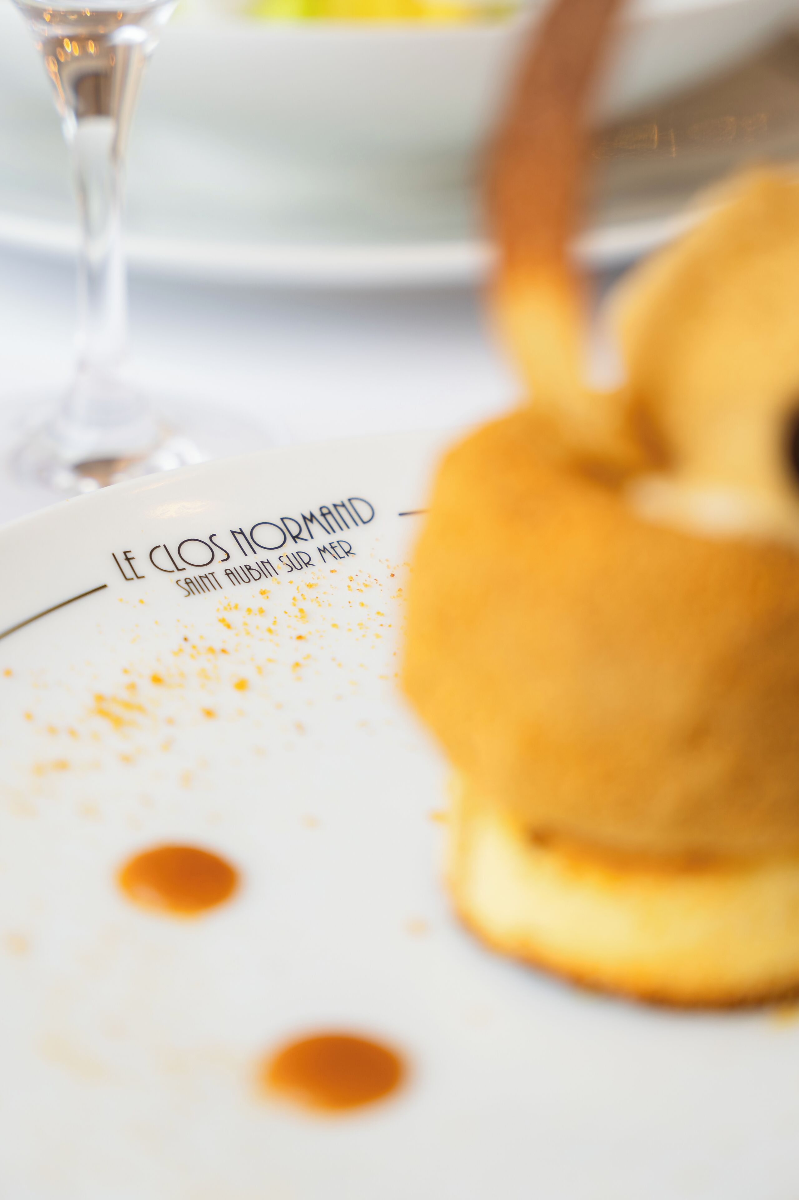 A dessert plate with text and sauce.