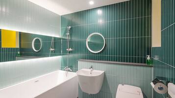 Un baño moderno con bañera, lavamanos e inodoro.