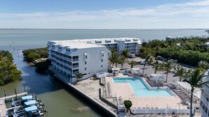 A hotel with a pool, a marina, and a view of the ocean.