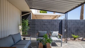 A covered outdoor seating area with a sofa, two chairs, and a coffee table. - 4BR Townhome | Pool | Old Town Scottsdale (Scottsdale)