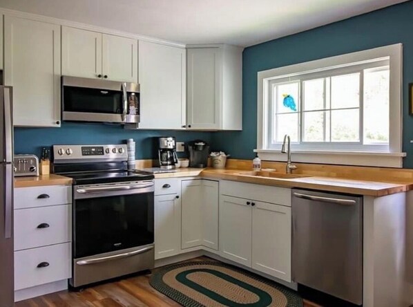 Enjoy cooking in this well-equipped kitchen with a microwave, oven, and dishwasher.