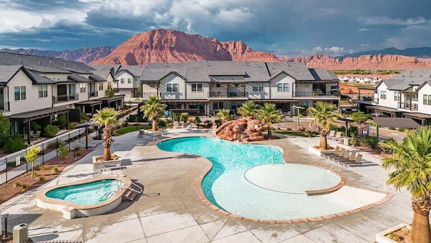 A resort with multiple swimming pools, a large central pool, and a mountainous backdrop. - O-65| Poolhouse at Ocotillo Springs * Private Pool (Santa Clara)
