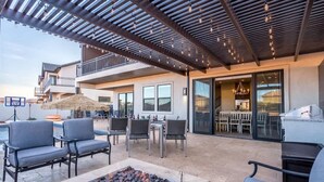 An outdoor patio with seating, a fire pit, and a pool area. - O-65| Poolhouse at Ocotillo Springs * Private Pool (Santa Clara)