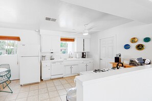 Enjoy cooking in this well-equipped kitchen with a central island and essential appliances.