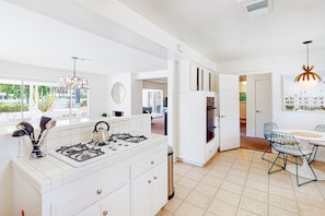 Enjoy cooking in this well-equipped kitchen with a gas stove and dining area overlooking the outdoors.
