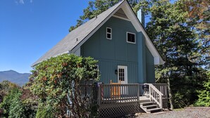 A two-story house with a porch, a small front yard, and a mountain backdrop. - Big Views, Hot Tub, Dog Friendly, 5min to BR (Blowing Rock)
