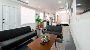 A compact living space with a sofa, armchairs, a coffee table, a kitchen area, and a bed. - Quaint cozy studio located in the heart of El Paso  (El Paso)