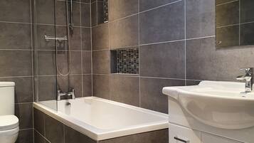 Combined shower/bathtub, towels, soap, toilet paper