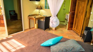 A bedroom with a bed, a desk, a chair, and a wardrobe. - T1 D'ALICE CLASS 2* 1.2 KM FROM BOURG BEACH (SAINTE ANNE)
