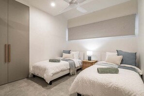 A bedroom with two beds, a ceiling fan, and a window with a blind. - From the minute you walk in the front door you will be in awe of the styling. (Lennox Head)