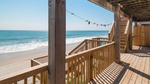 A wooden deck with a view of the beach and ocean. - Oceanfront Oasis House 5 bedroom, 3.5 bath Elevator - Excellent Reviews (Holly Ridge)