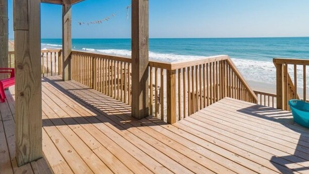 A wooden deck with a view of the ocean. - Oceanfront Oasis House 5 bedroom, 3.5 bath Elevator - Excellent Reviews (Holly Ridge)