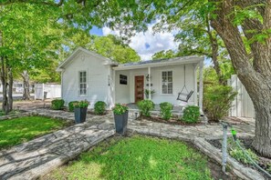 A single-story house with a front porch, a small attached garage, and a mailbox. - Romantic-Steps To Main-FirePit! (Fredericksburg)