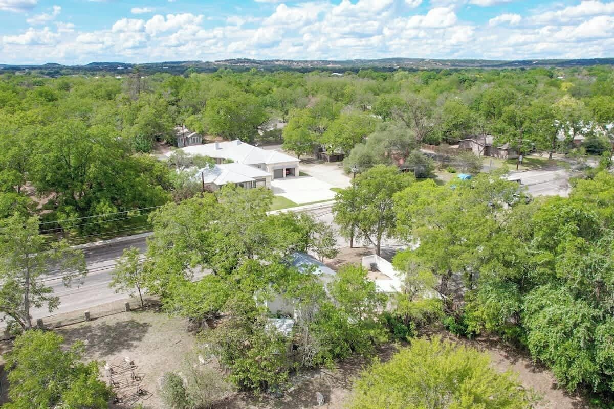 A residential area with multiple houses surrounded by dense greenery.