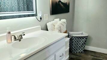 Bathtub, hair dryer, towels, soap