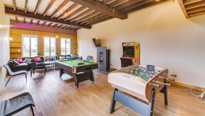 A cozy indoor space with a pool table, foosball table, and a sofa area. - Crazy Villa Radar (89) - Heated pool - Multisports field - 2h Paris - 30p. (Saint-Cyr-les-Colons)