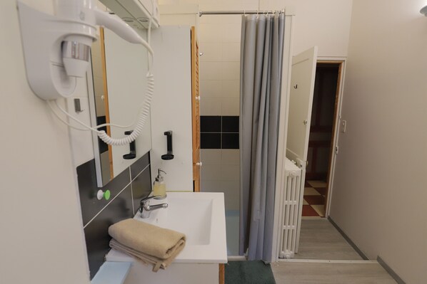 Bathtub, hair dryer, soap, shampoo