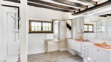Bathtub, hair dryer, shampoo, toilet paper