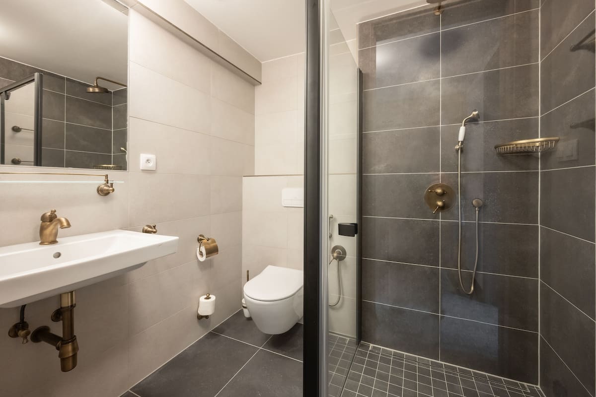 junior suite with balcony (spa access) | bathroom | rainfall showerhead, designer toiletries, hair dryer, bathrobes