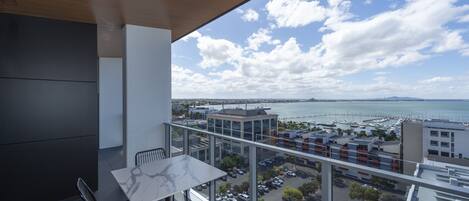 A balcony with a view of a marina and buildings.