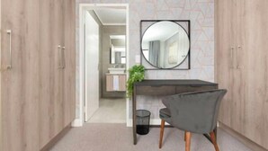A modern room with a wooden wardrobe, a round mirror on the wall, a grey chair, and a small table with a plant. - Waters Edge 503 (Cape Town)