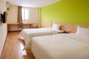 A hotel room with two beds, a desk, and a chair. - 7 Days Inn (Huizhou)