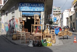 A furniture store with various wooden items displayed outside. - Architect designed studio (EP7R). Green rooftop! (Athina)