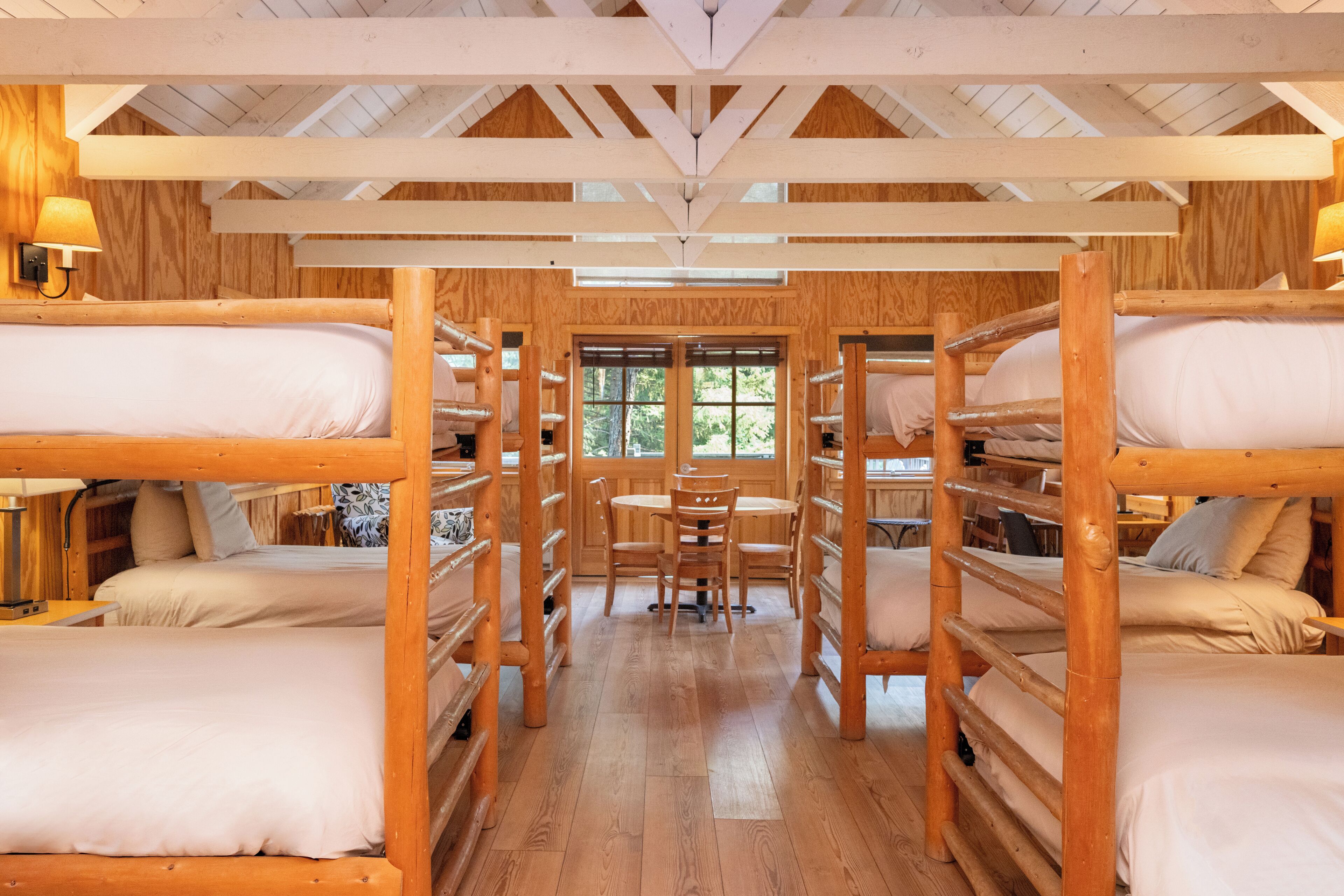 A cabin with bunk beds arranged around a central dining table.