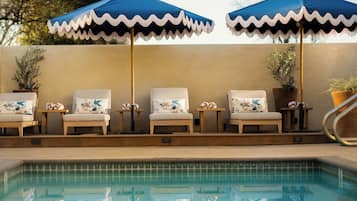 Outdoor pool, open 9:00 AM to 9:00 PM, pool umbrellas, pool loungers