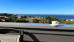 A view from a balcony overlooking a coastal area with houses and the ocean. - Dazzling Luxury Ocean views, Hot Tub, Golf, AC, Theater, Chef Options @SwitiHoso (Bodega Bay)