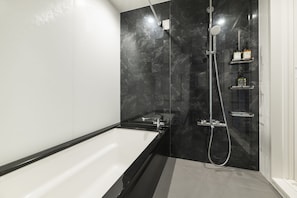 Separate bathtub and shower, free toiletries, hair dryer, slippers