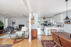 Relax in this open-plan living space with a sofa, coffee table, and dining area.