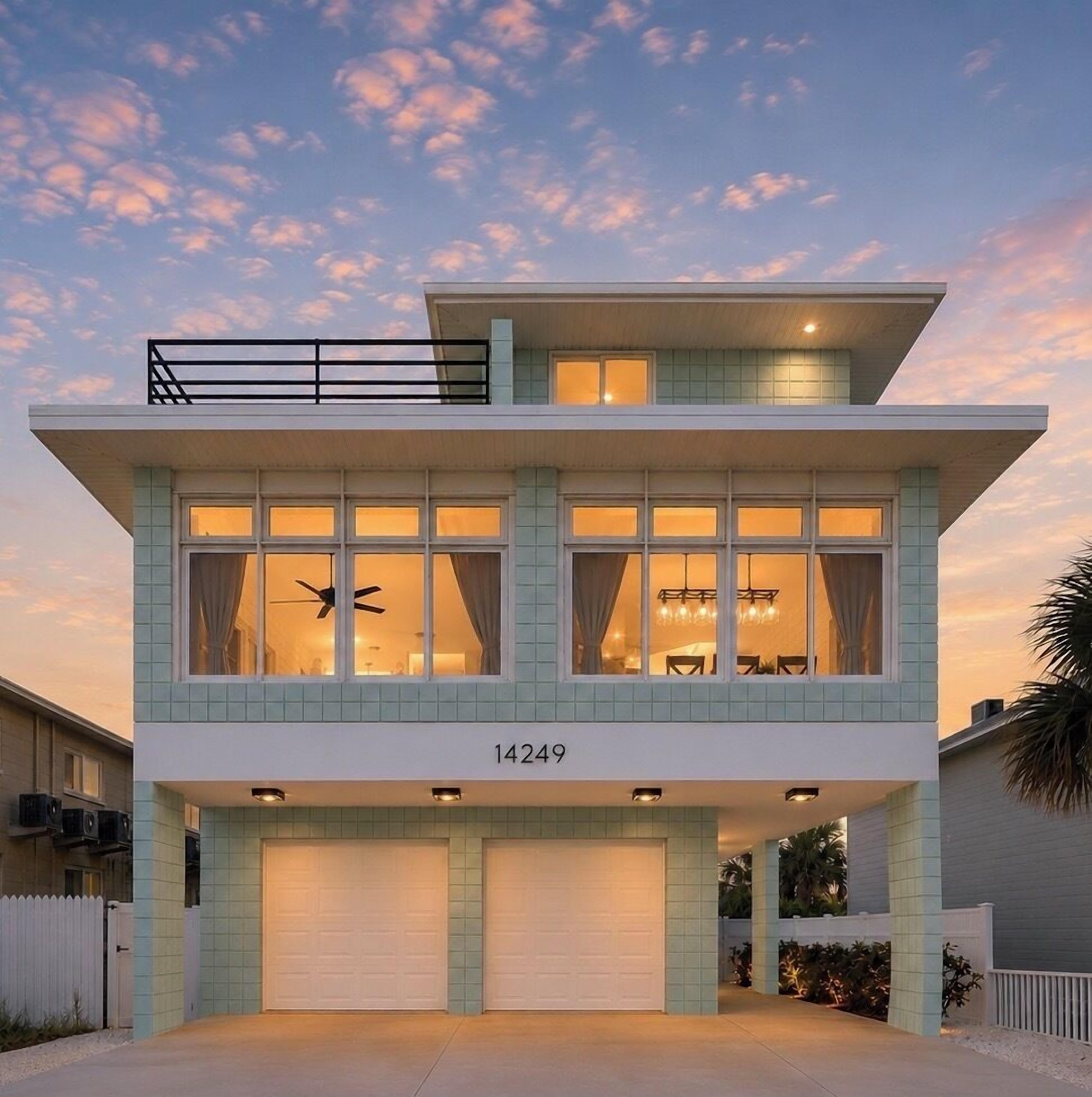 A two-story house with a flat roof, large windows, and a garage.