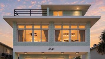 A two-story house with a flat roof, large windows, and a garage.