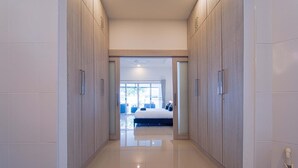 A hallway leading to a bedroom with a bed, a window, and a door. - Cozy 3 Bedroom Pool Villa L70 (Hua Hin)