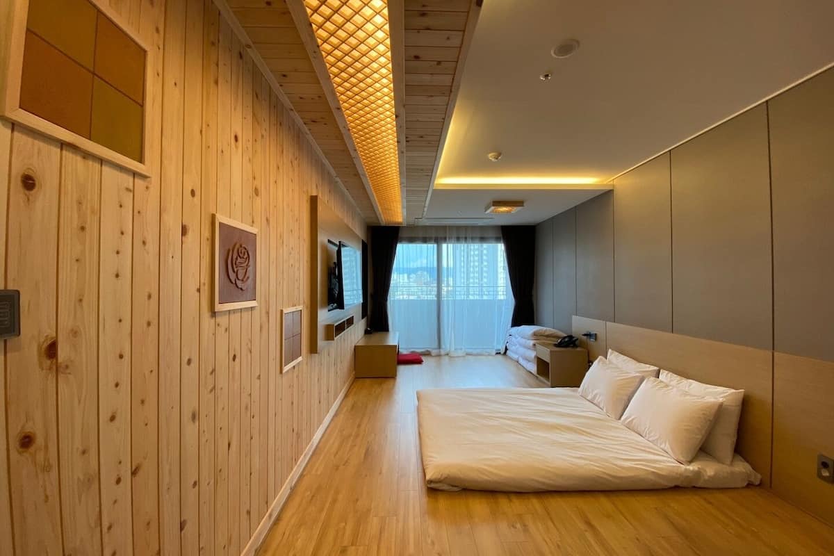 family room (ondol) | down duvets, desk, laptop workspace, blackout curtains