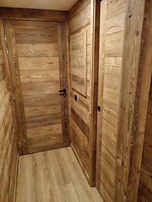 The door features a natural wood grain pattern and a modern handle.